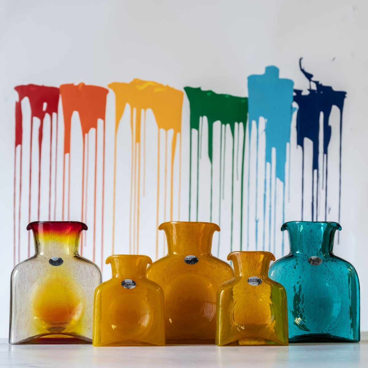 Experimental color bottles with painting in background