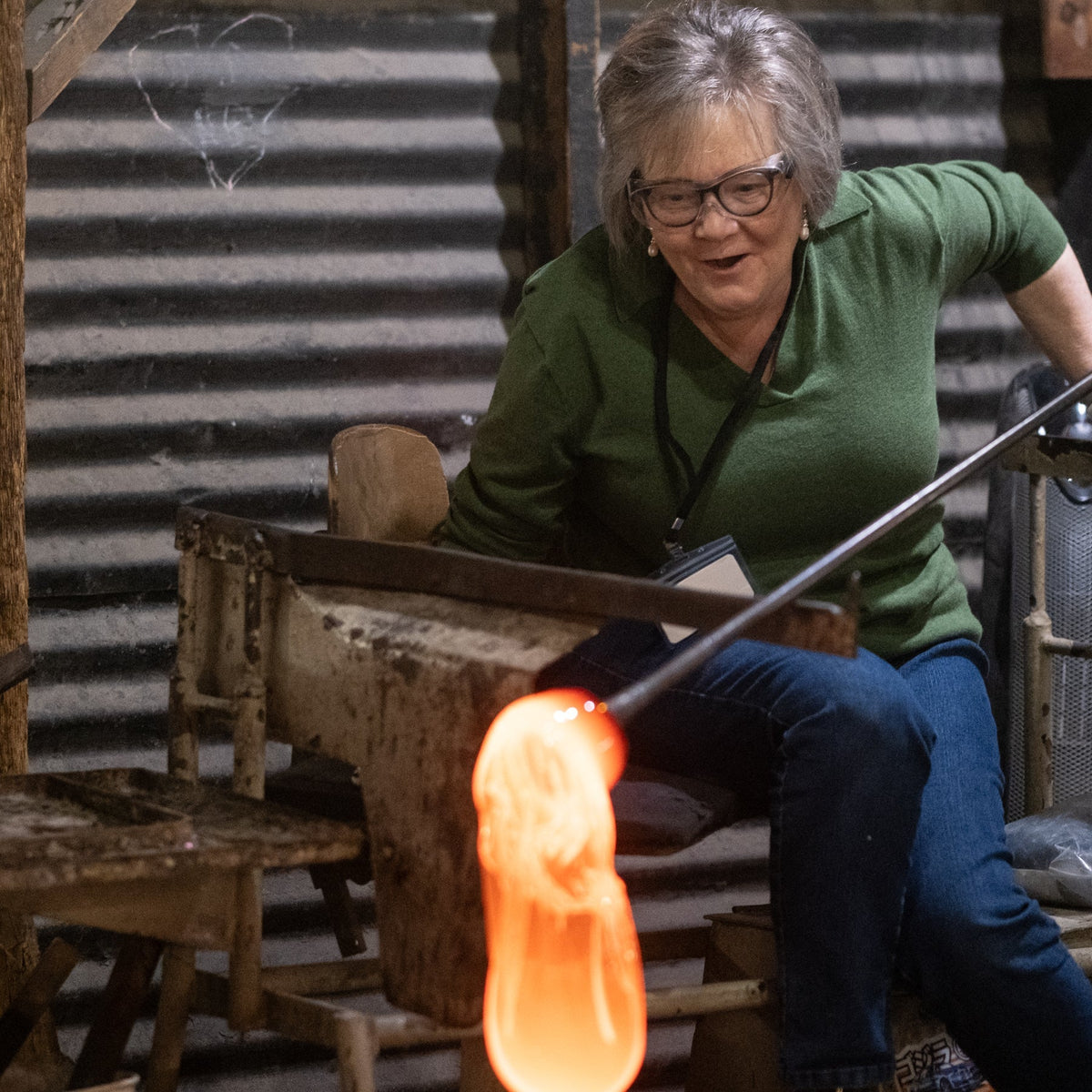Glassworker working with molten glass