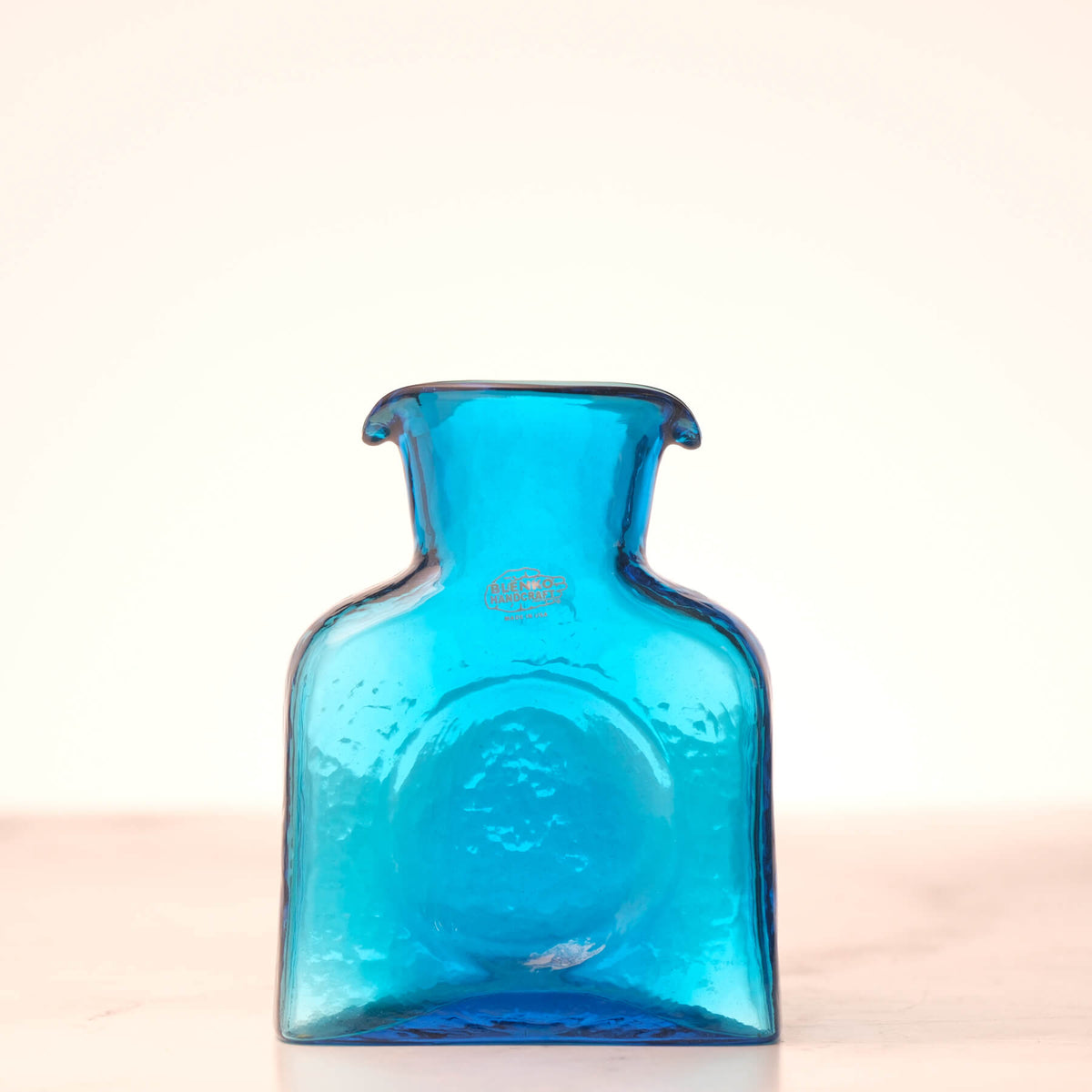 Blue glass bottle on a white background