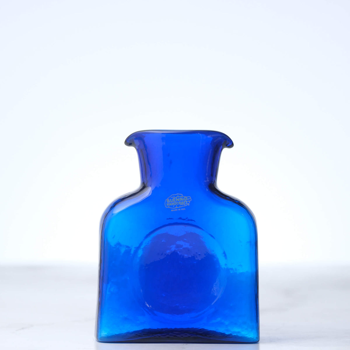 Blue glass bottle on a white background