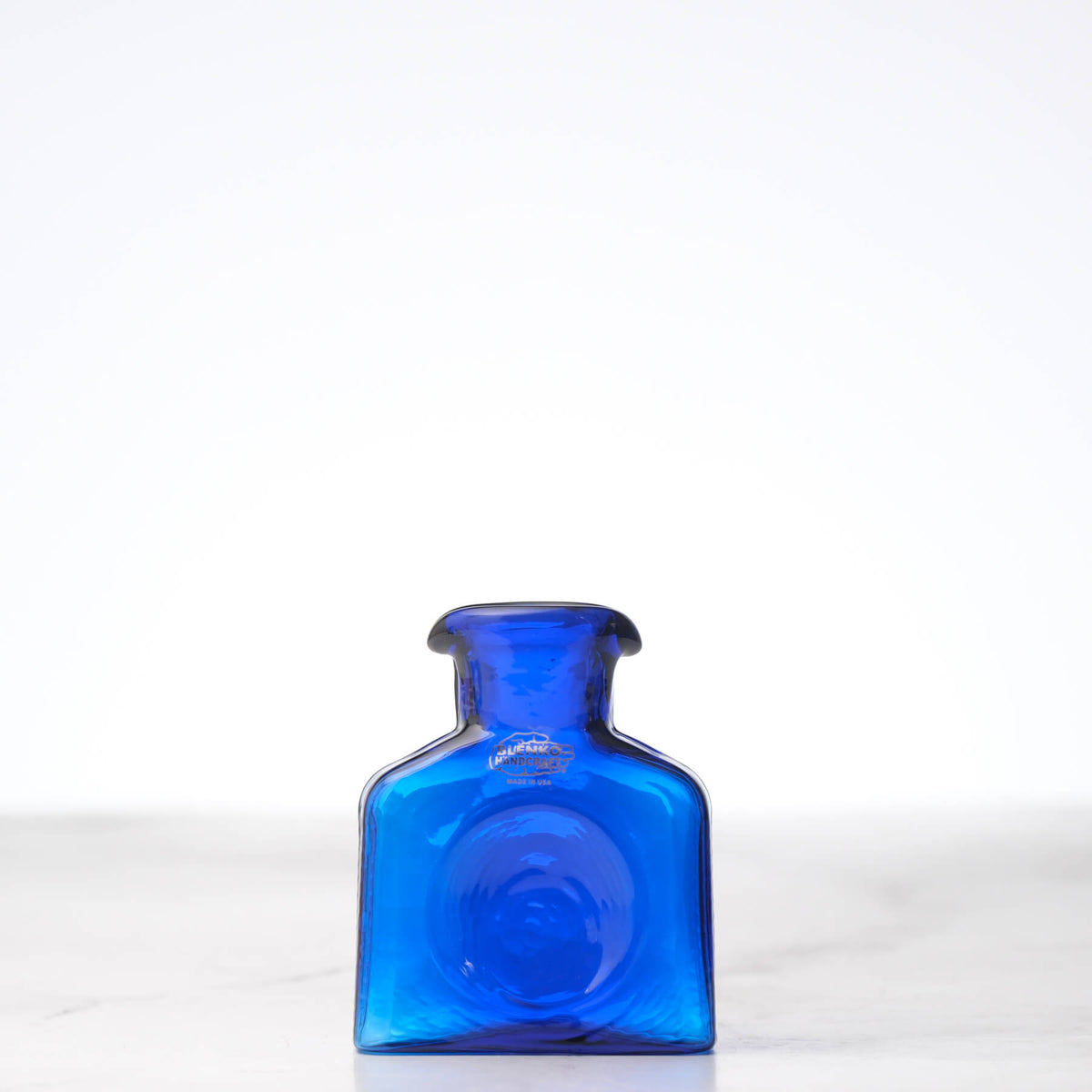 Blue glass bottle on a white background