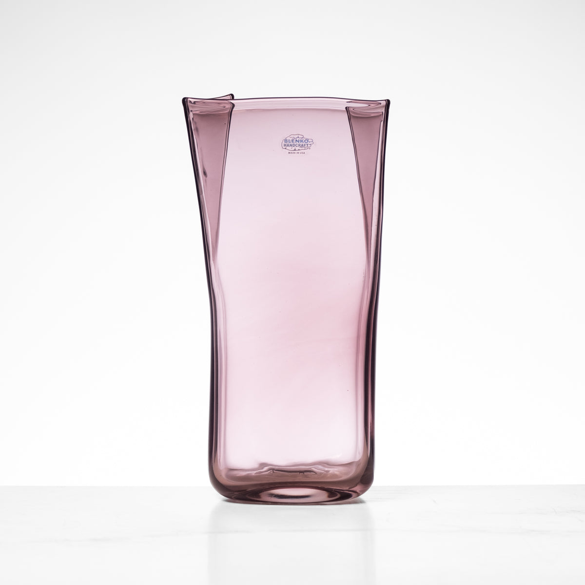 Pink glass vase on a white background