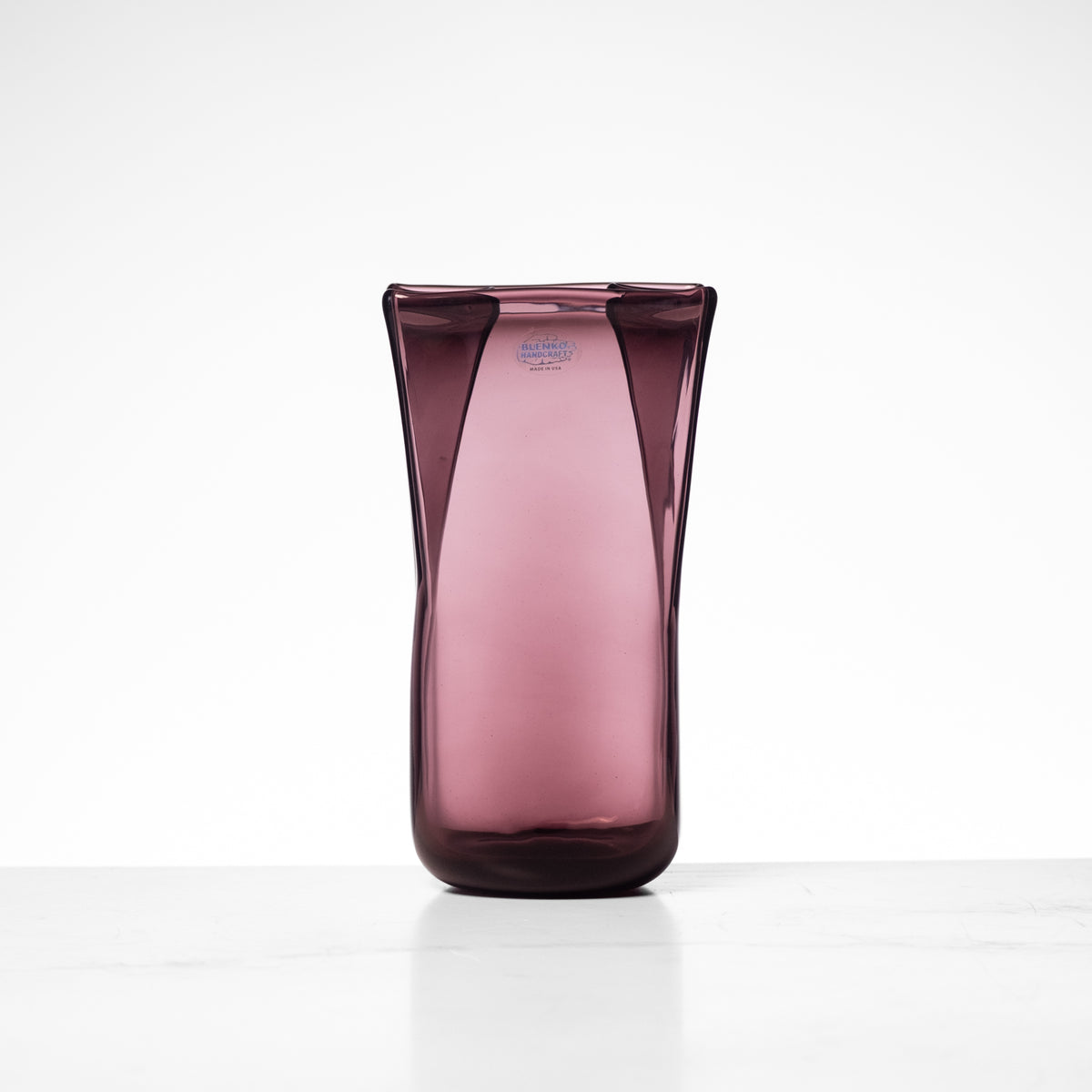 Pink glass vase on a white background