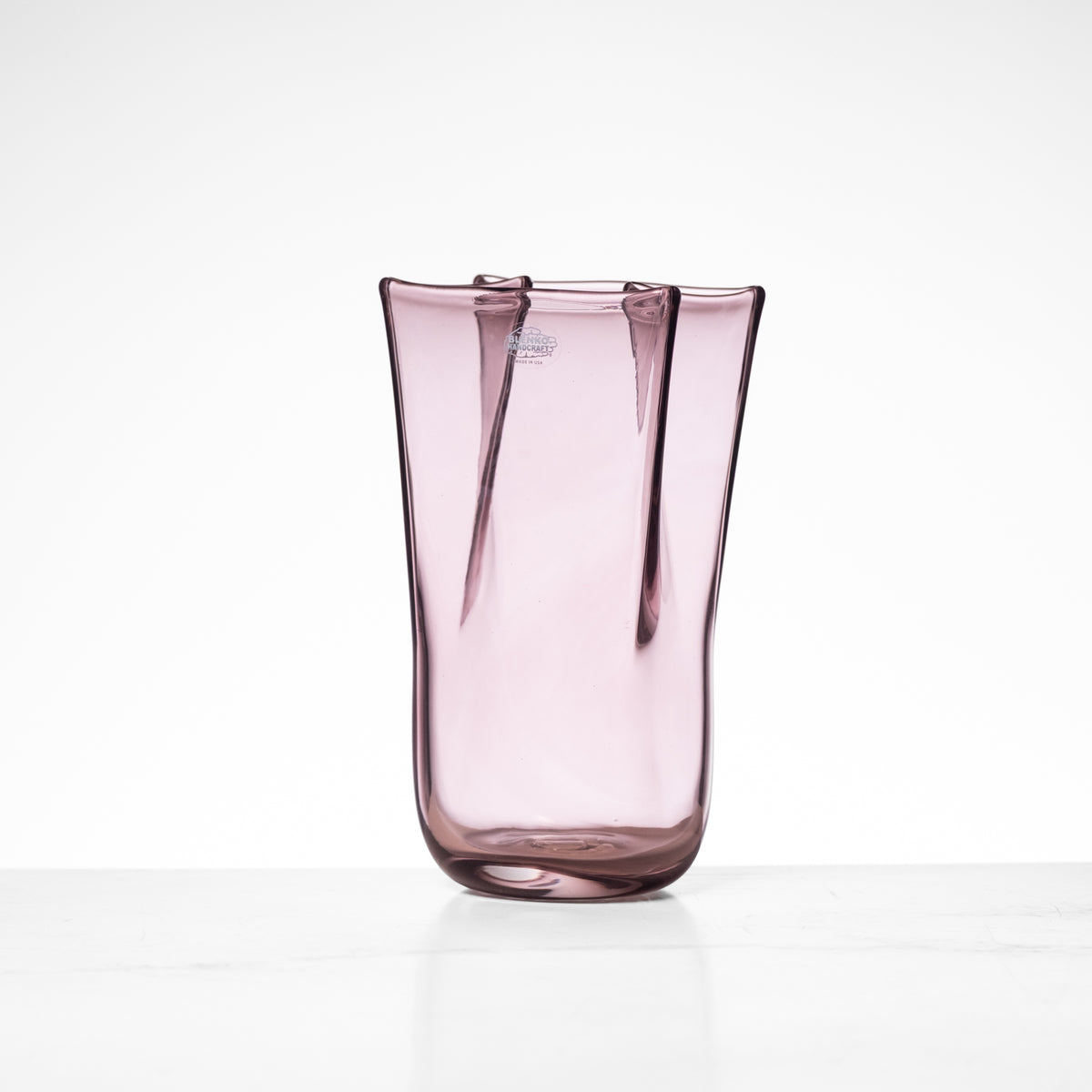 Pink glass vase on a white background