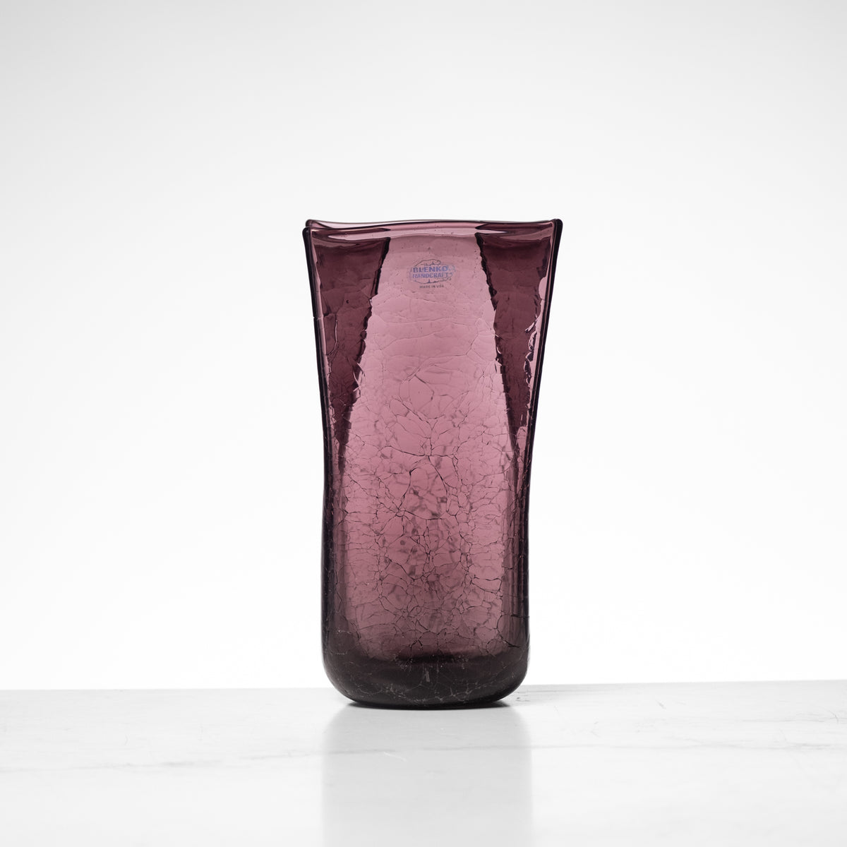 Purple textured vase on a white background