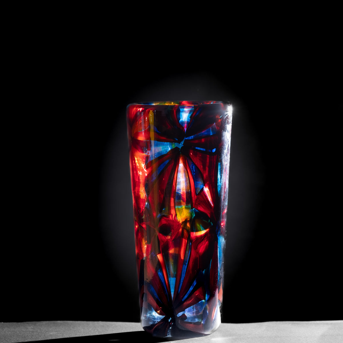 Colorful glass vase on a dark background