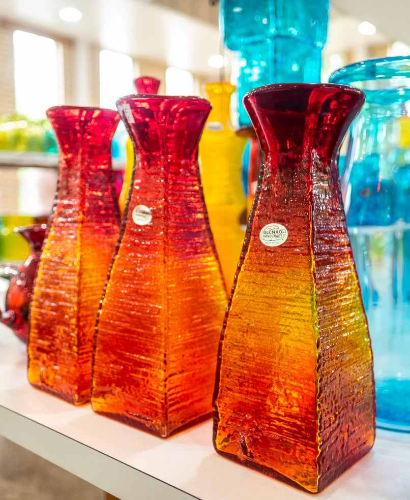 3 tall tangerine colored vases