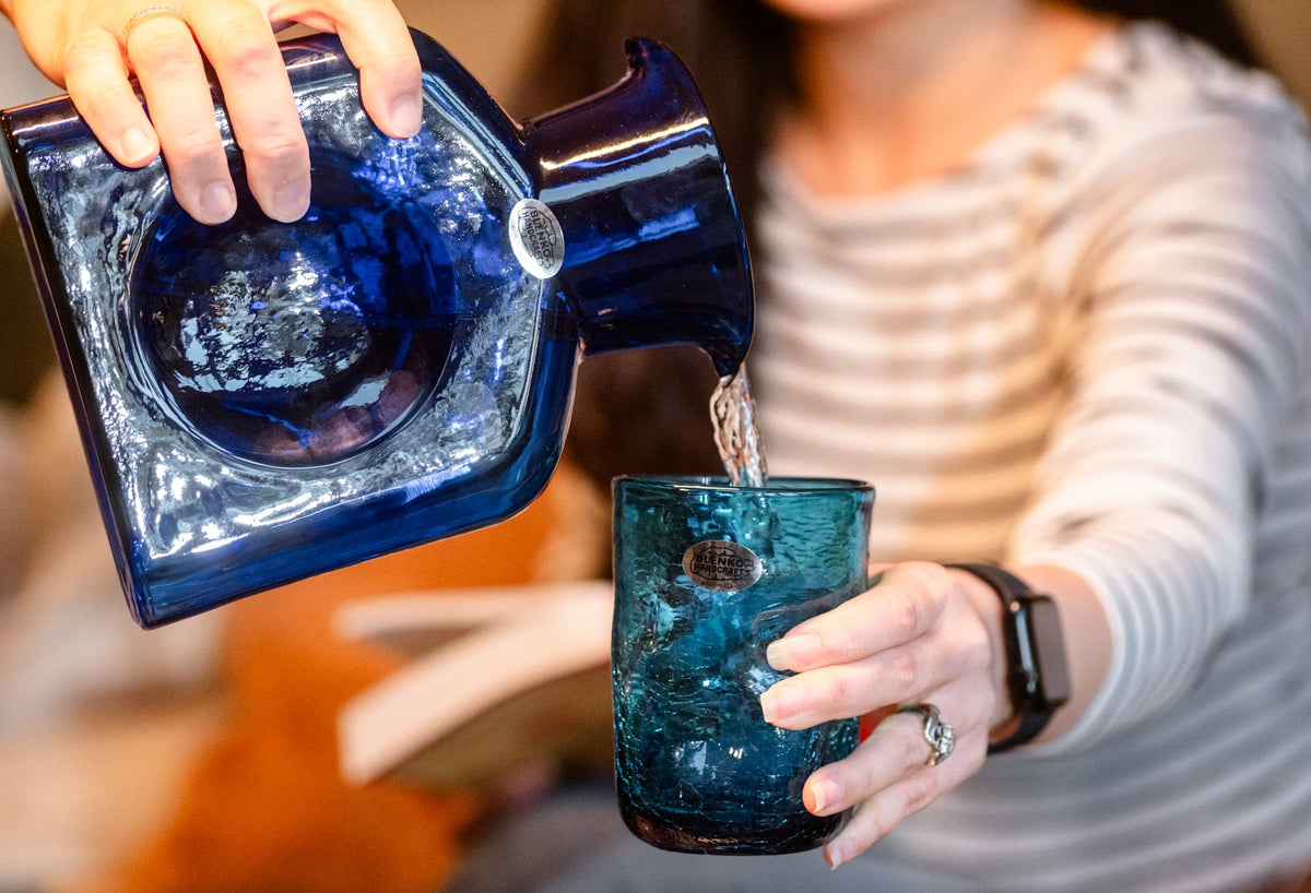 Pouring water into a drinking glass