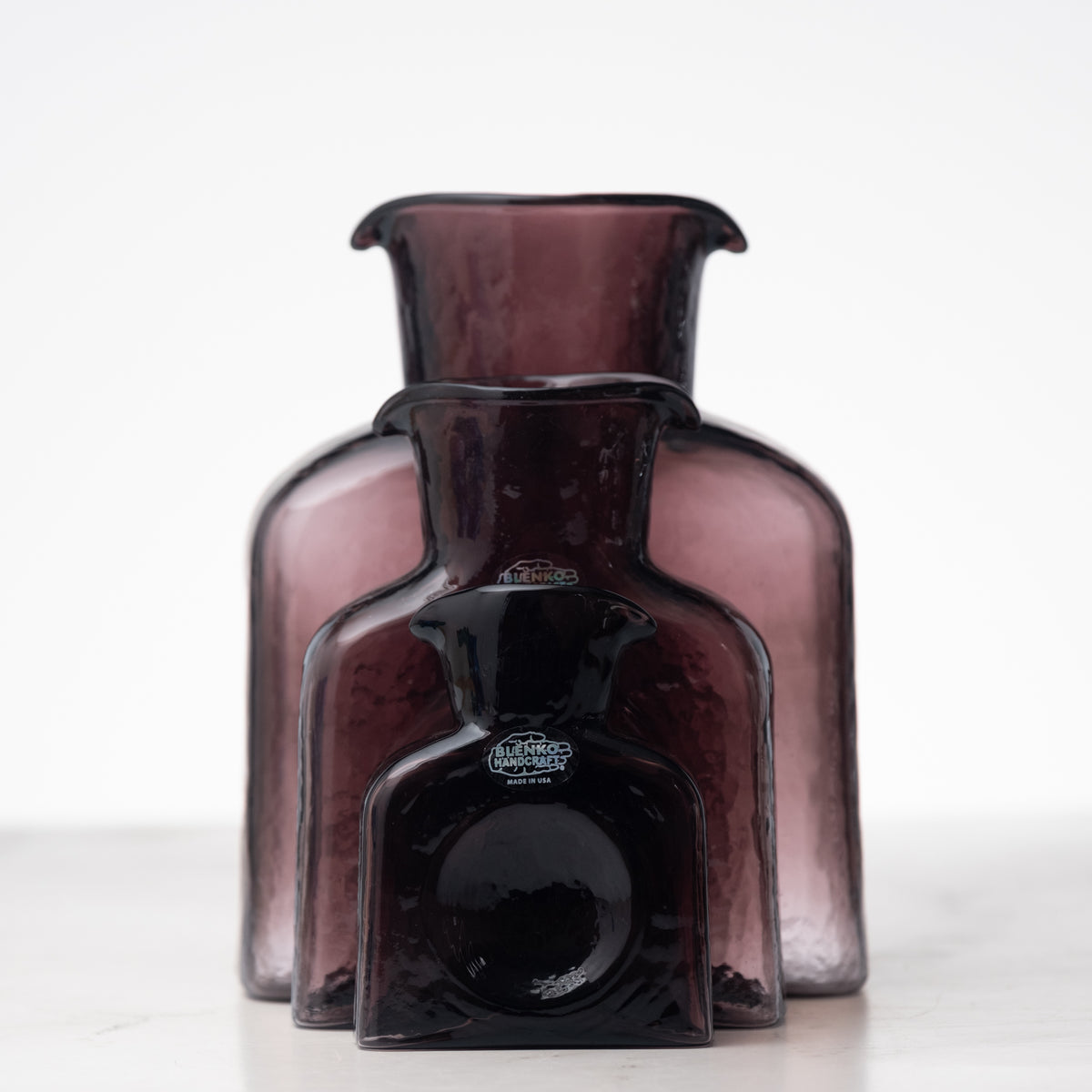 Amethyst-colored glass vase with 'Baccarat' branding on a white background