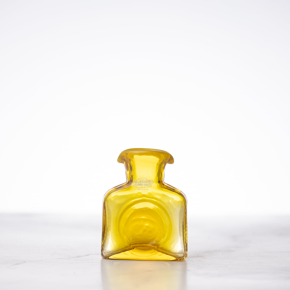 Yellow glass bottle on a white background
