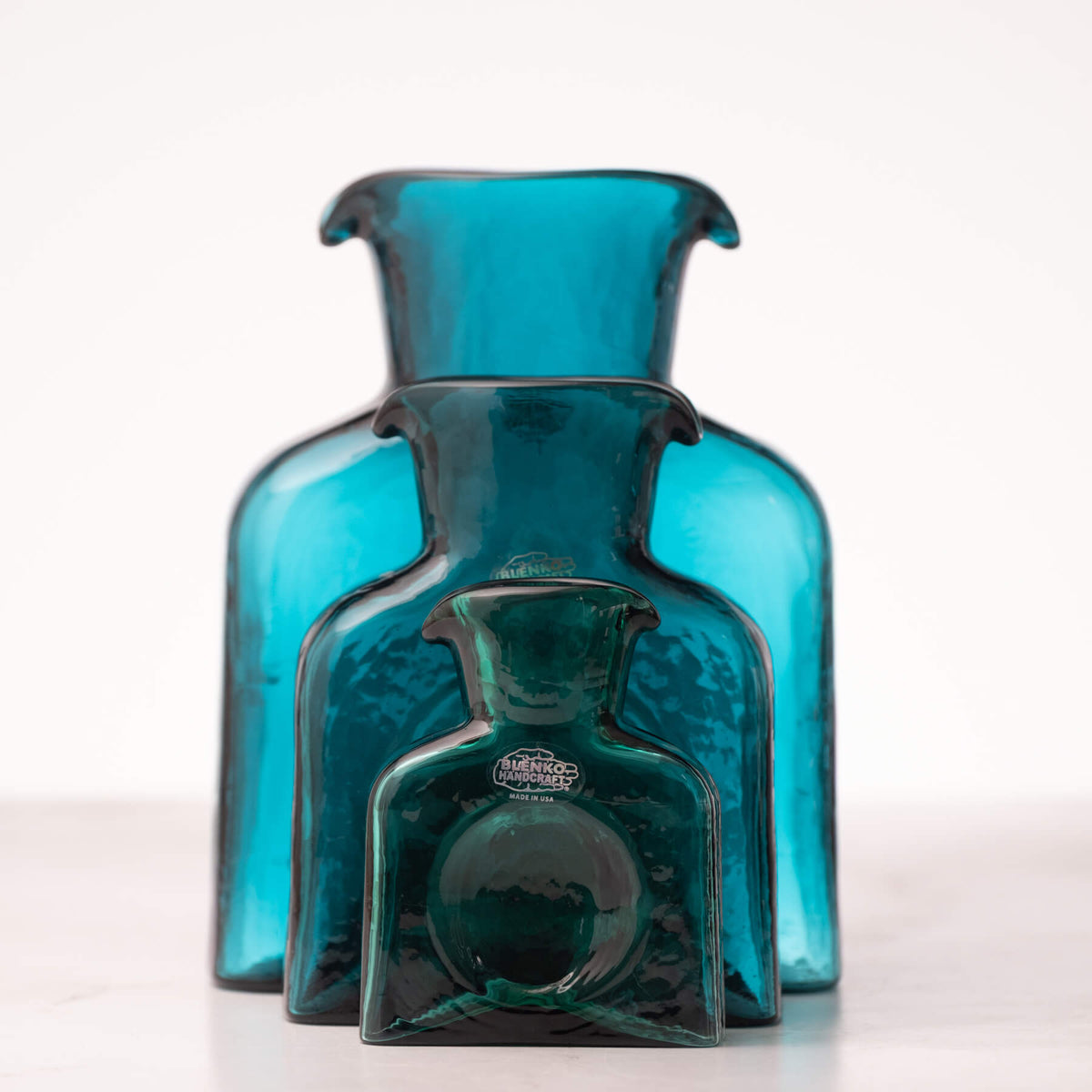 Blue glass bottle with a label on a white background