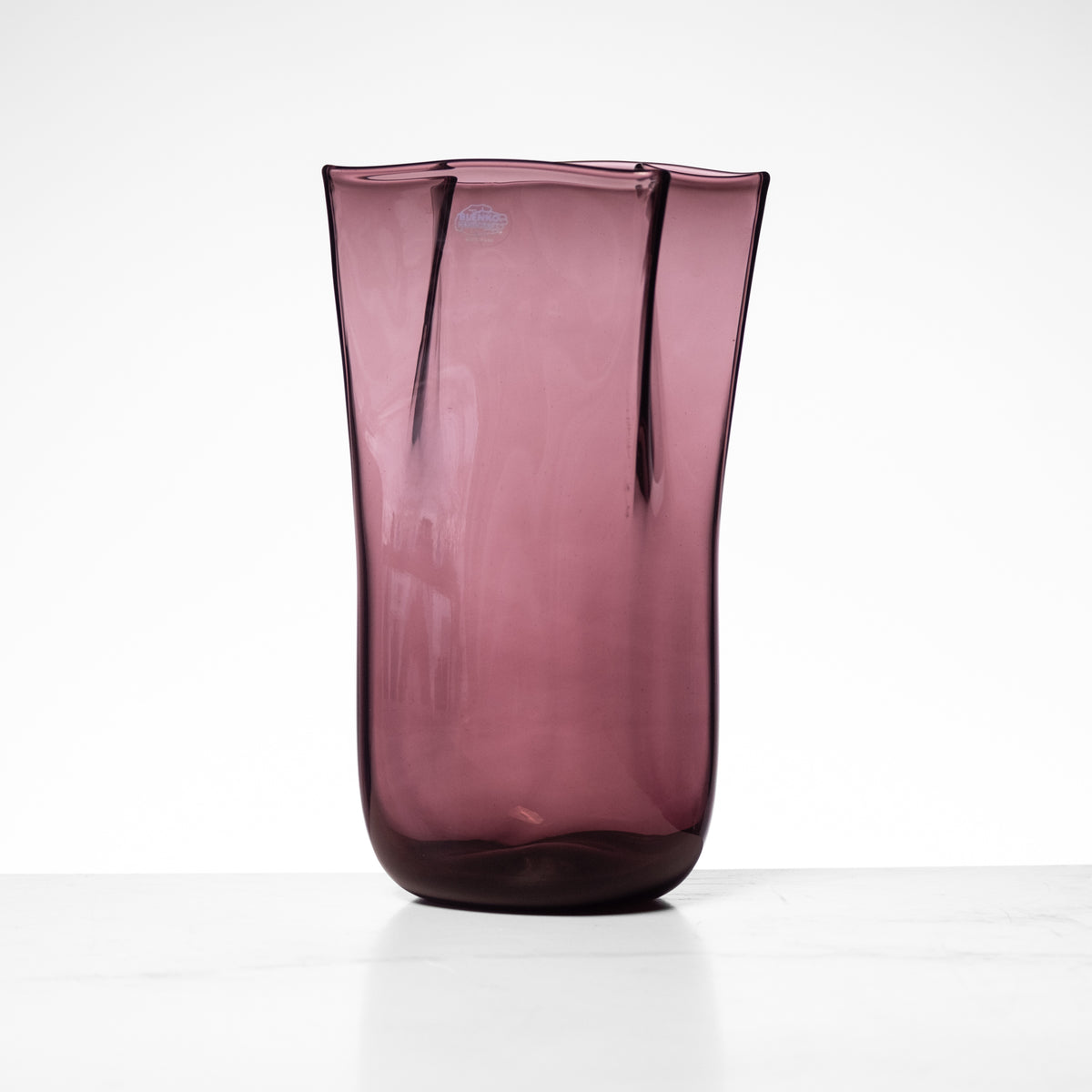 Purple glass vase on a white background