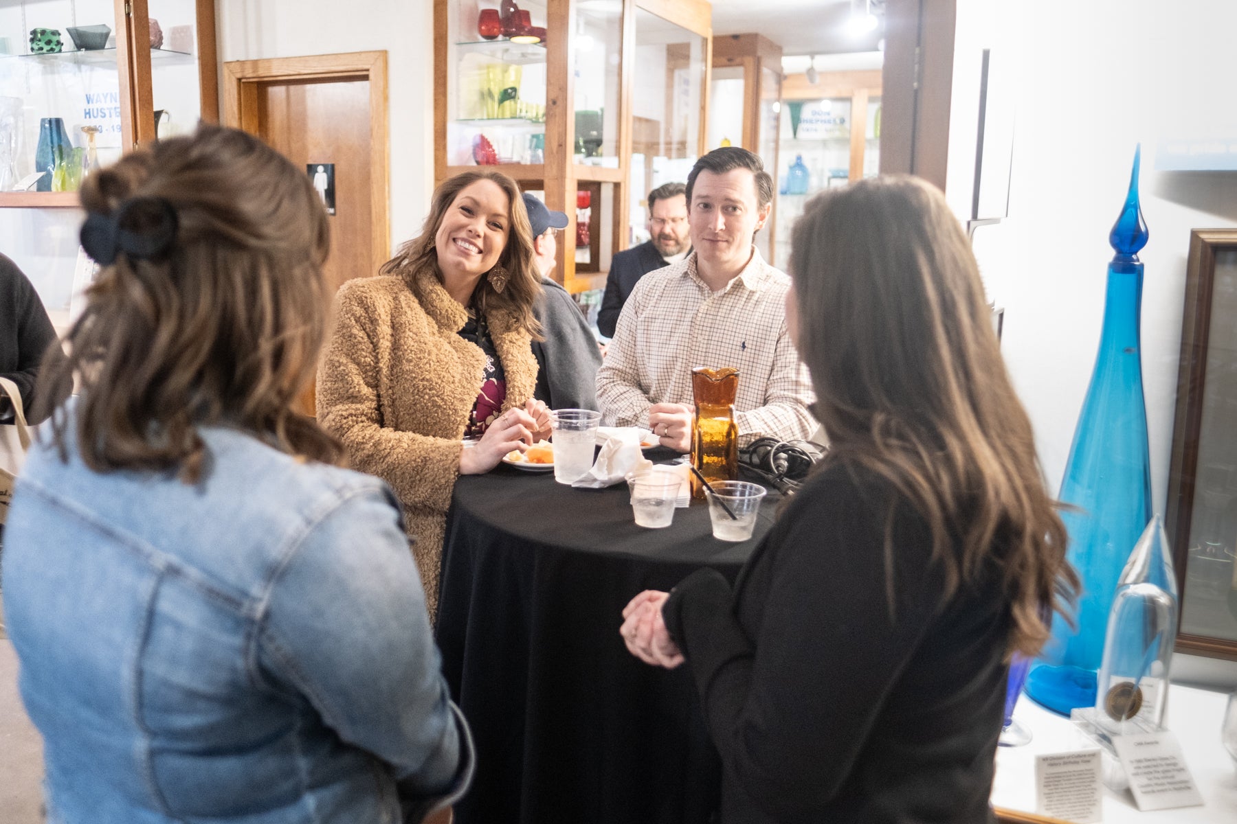 Group of people gathered around a table in a casual setting