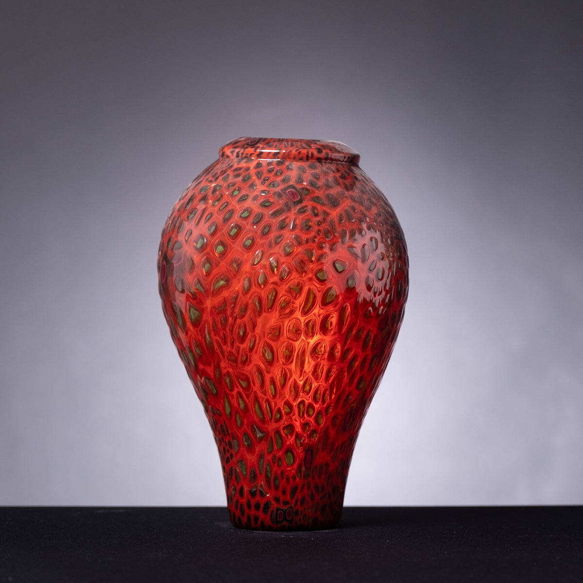 Red textured vase on a gray background
