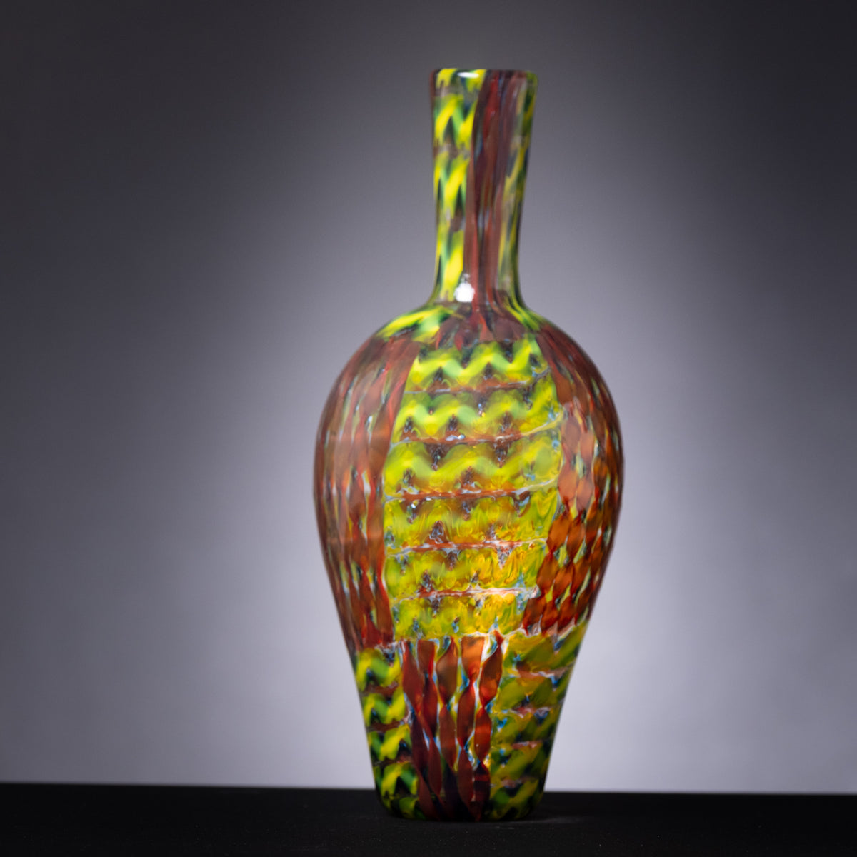 Multicolored glass vase on a gray background