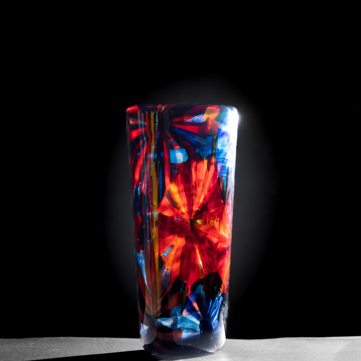 Colorful glass vase on a dark background