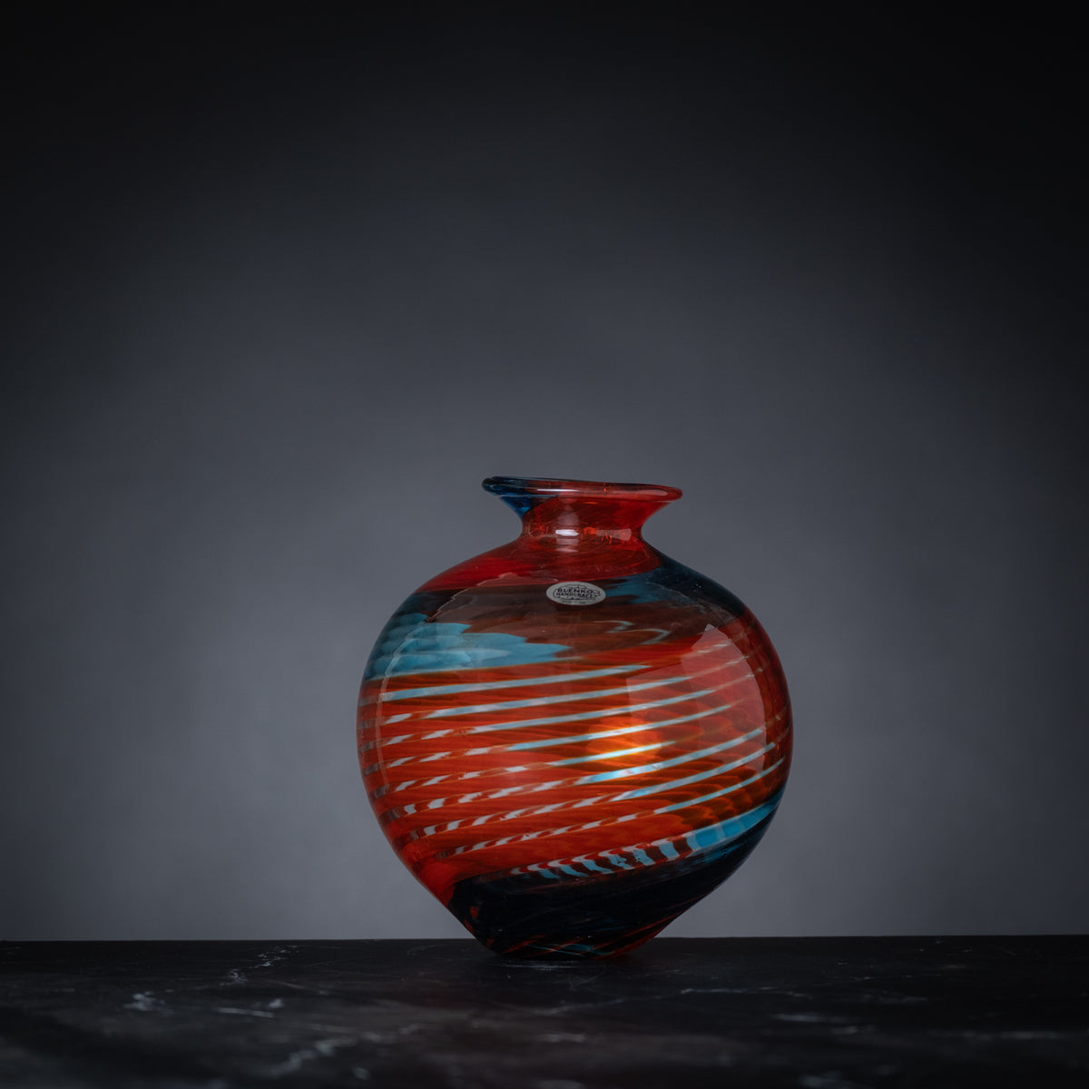 Colorful vase with abstract design on a dark background