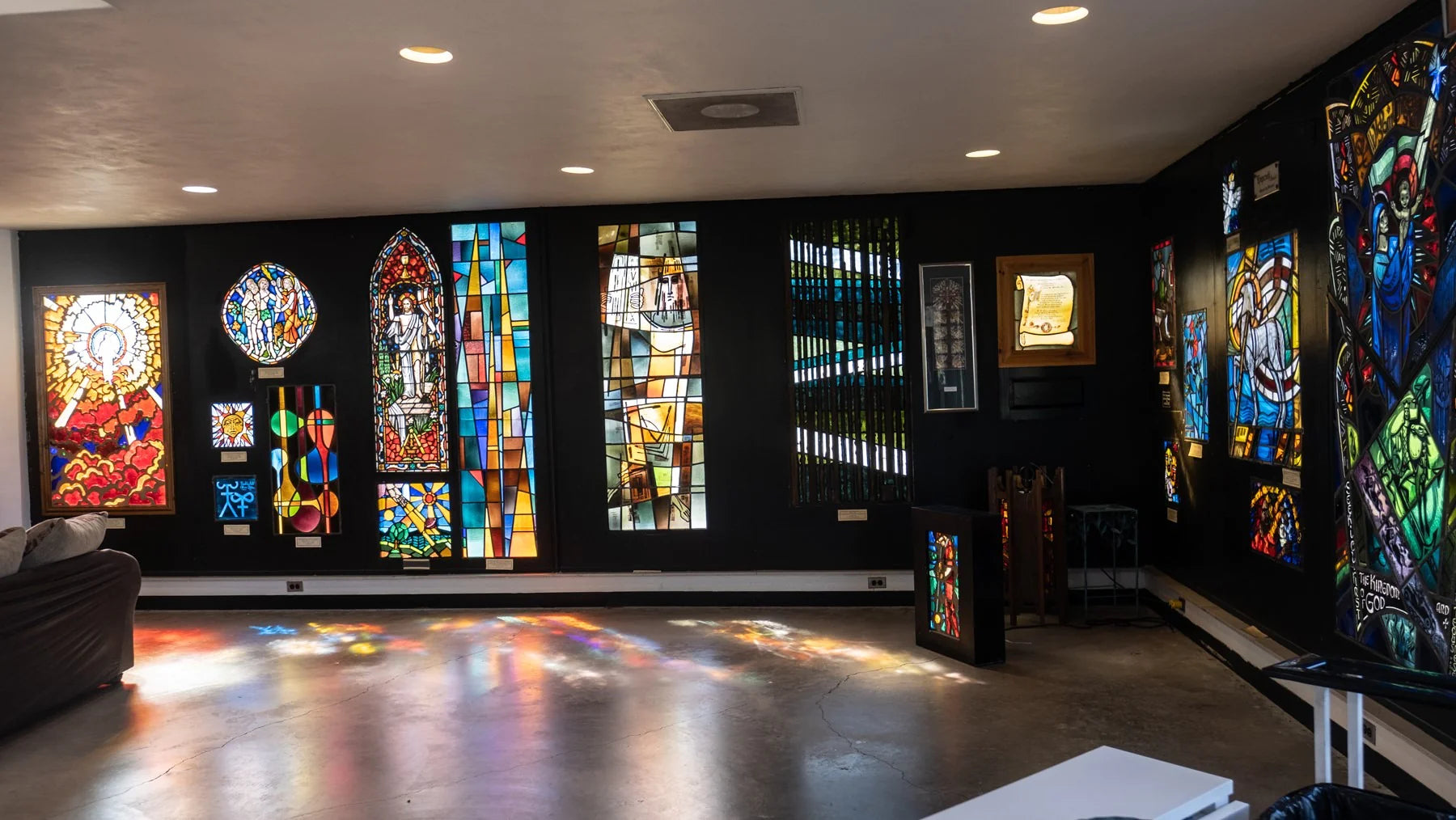 Stained glass windows in a room with black walls